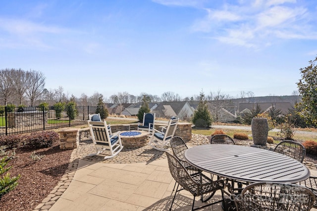 view of patio / terrace featuring an outdoor fire pit, outdoor dining area, and fence