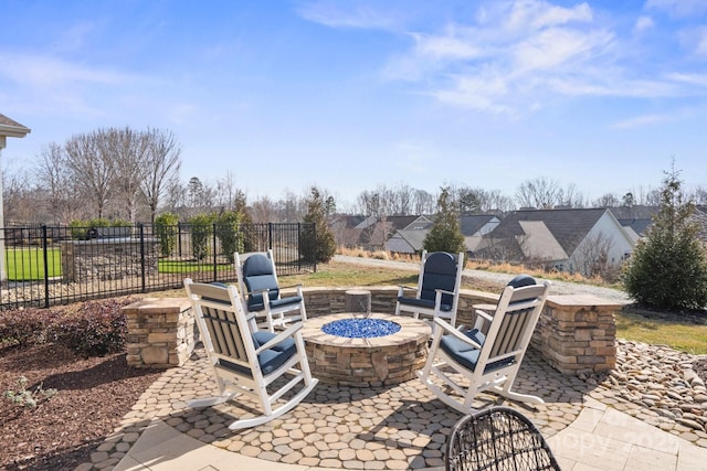 view of patio / terrace with a fire pit and fence