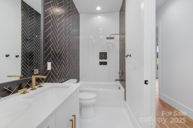 full bathroom featuring tile walls, vanity, tiled shower / bath combo, toilet, and hardwood / wood-style flooring