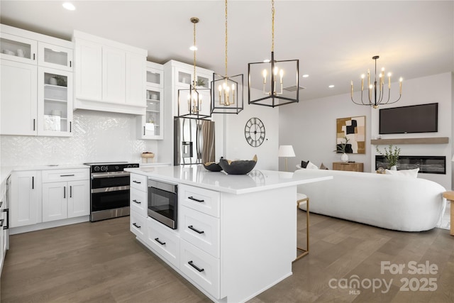 17201 Green Hill Rd, Charlotte, NC 28278 - kitchen featuring a chandelier, wood finished floors, open floor plan, and appliances with stainless steel finishes