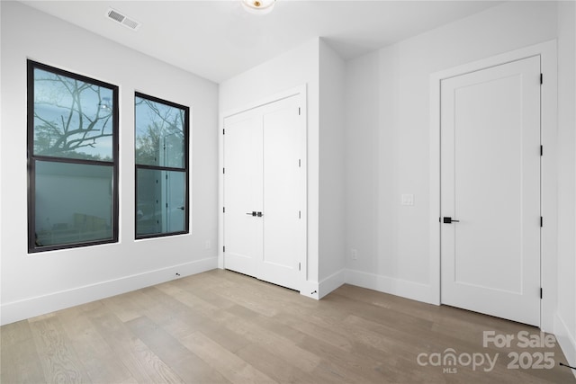 17201 Green Hill Rd, Charlotte, NC 28278 - unfurnished bedroom with baseboards, visible vents, and wood finished floors