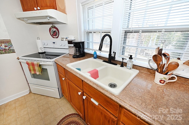 kitchen featuring sink and electric range