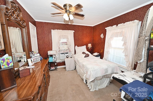 bedroom featuring carpet floors, ornamental molding, and ceiling fan