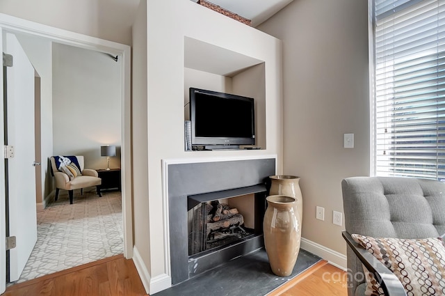 office with a fireplace, baseboards, and wood finished floors