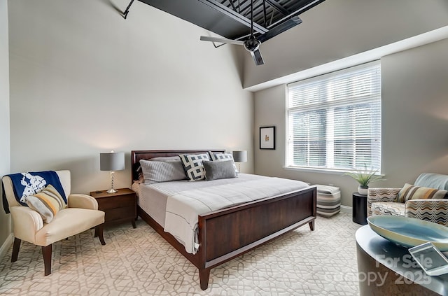 bedroom with baseboards and light colored carpet