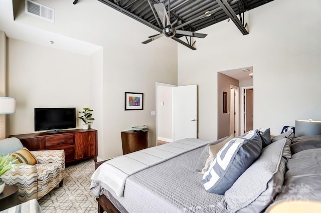 bedroom featuring a towering ceiling and visible vents