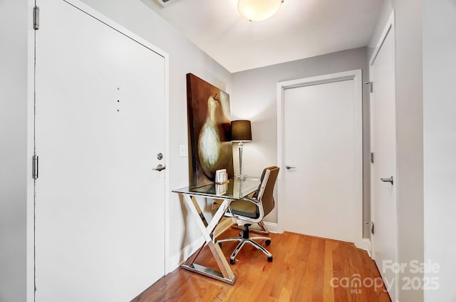 office area with baseboards and wood finished floors