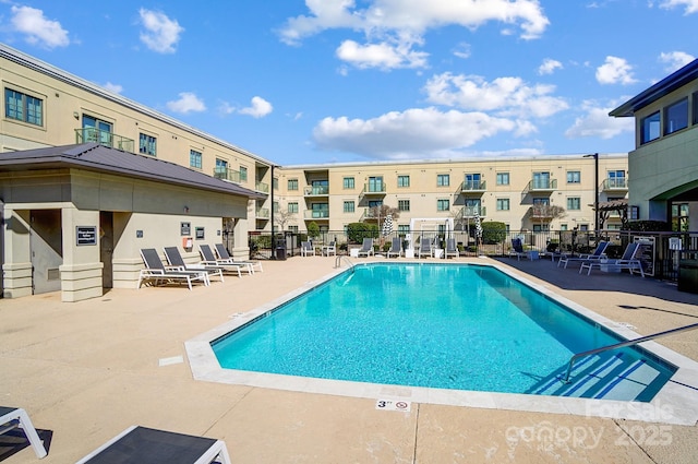 pool with fence and a patio