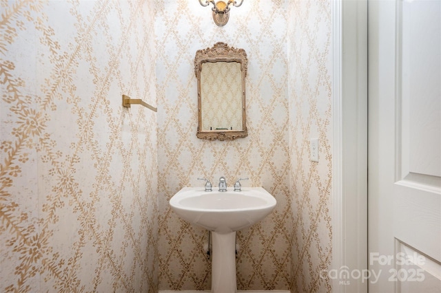 bathroom with wallpapered walls