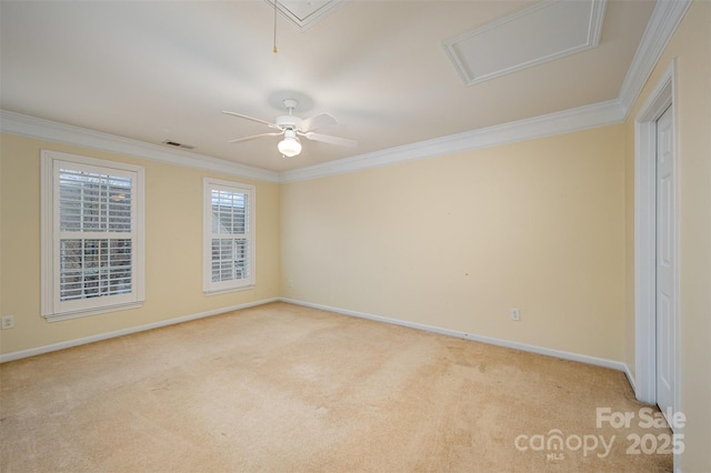 unfurnished room featuring light carpet, baseboards, visible vents, and crown molding