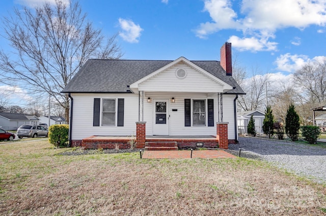 view of front facade with covered porch and a front yard