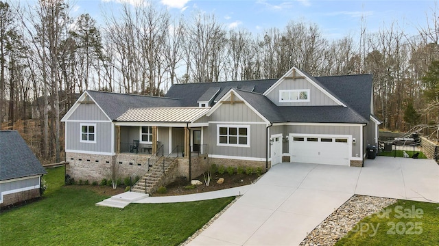 view of front of home with concrete driveway, a porch, board and batten siding, and a front lawn