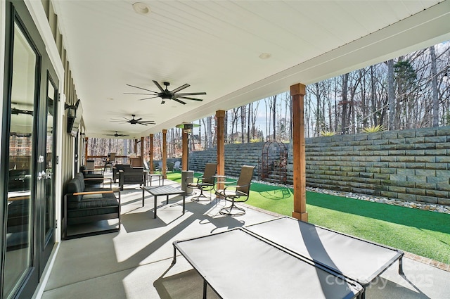 view of patio featuring a ceiling fan, a fenced backyard, and an outdoor living space