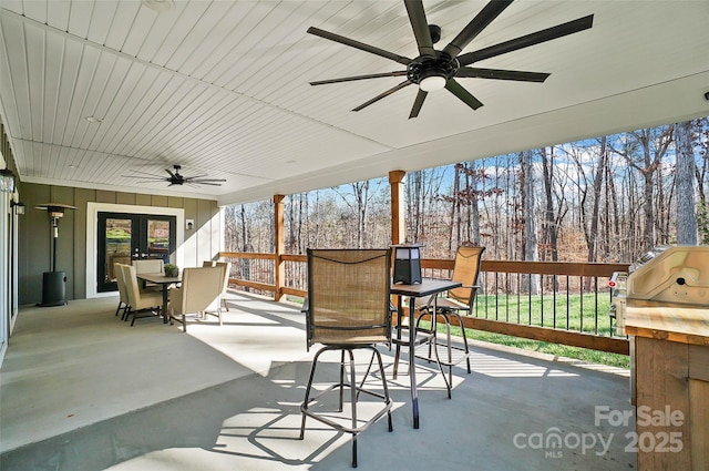 view of patio / terrace featuring ceiling fan, french doors, outdoor dining area, and area for grilling