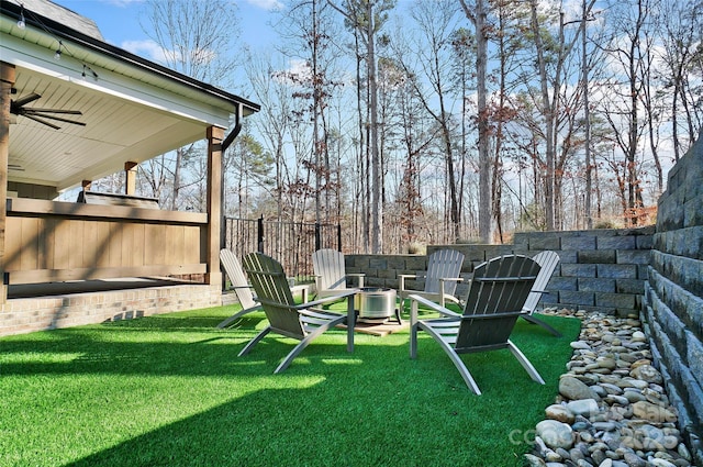 view of yard with a ceiling fan and a fenced backyard