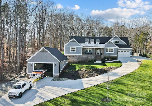 view of front of home featuring a garage, stone siding, a front lawn, a porch, and board and batten siding