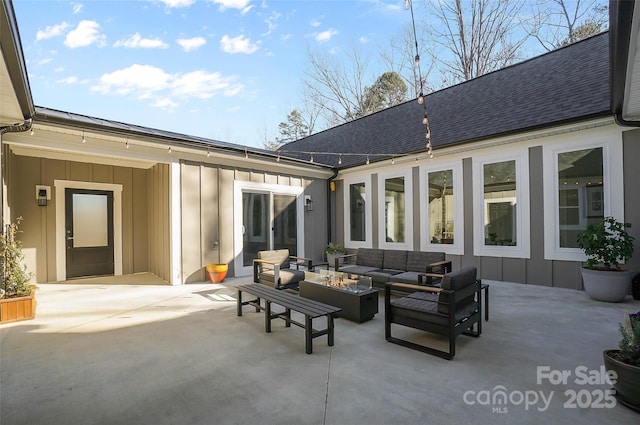 view of patio / terrace with an outdoor living space with a fire pit