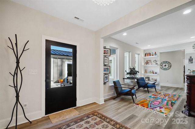 entryway with light wood-type flooring, visible vents, baseboards, and recessed lighting