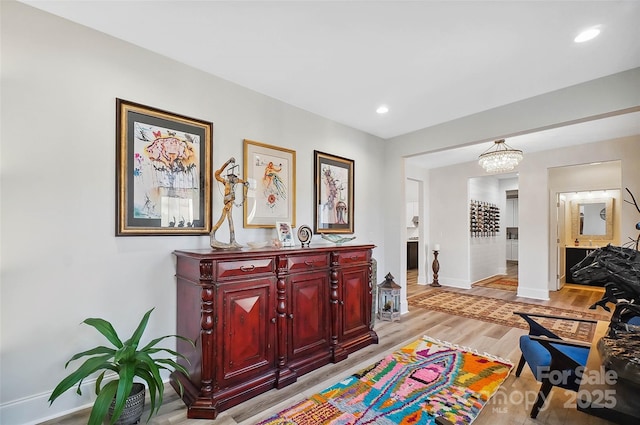 interior space with baseboards, light wood finished floors, and recessed lighting