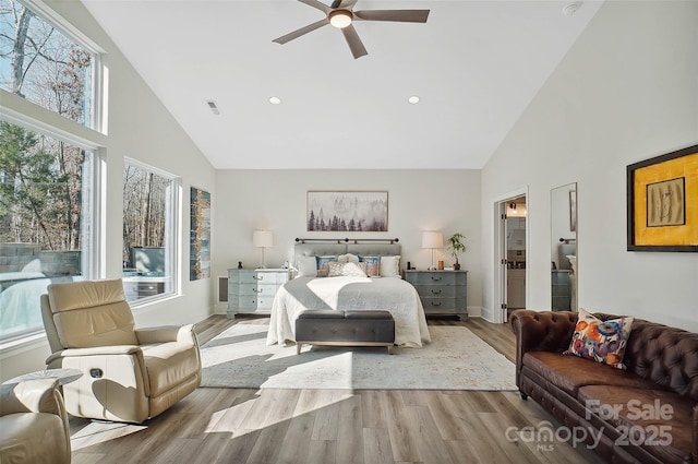 bedroom featuring light wood finished floors, visible vents, high vaulted ceiling, and recessed lighting