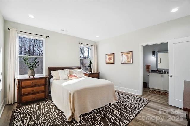 bedroom featuring baseboards, visible vents, wood finished floors, and recessed lighting