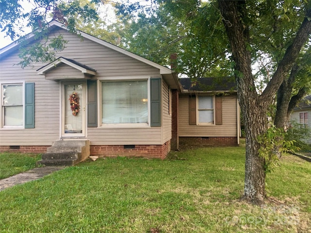 view of front of home with crawl space and a front lawn