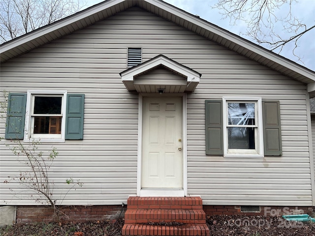 view of front of house with crawl space and entry steps