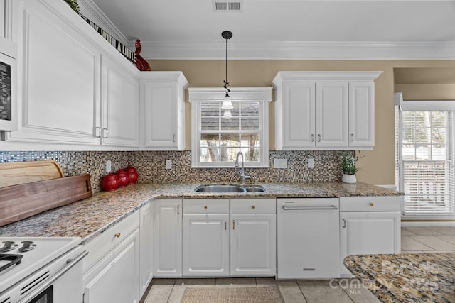 kitchen with white cabinetry, crown molding, light stone counters, and sink