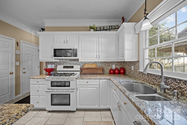 kitchen with white cabinetry, double oven range, hanging light fixtures, and sink