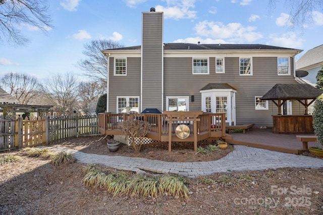 rear view of property featuring a deck