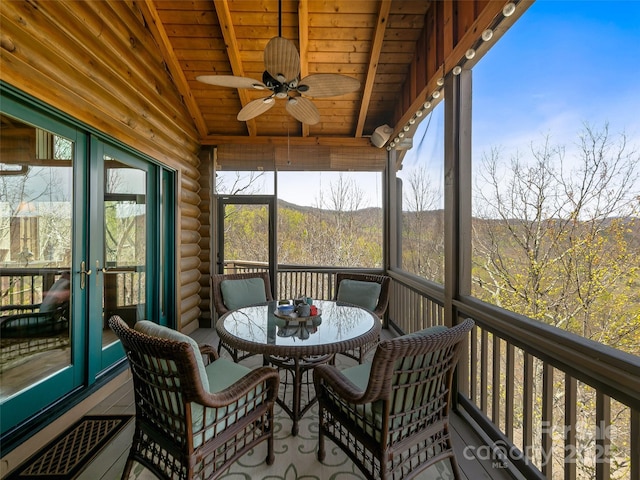 sunroom / solarium with wooden ceiling, visible vents, vaulted ceiling, and ceiling fan