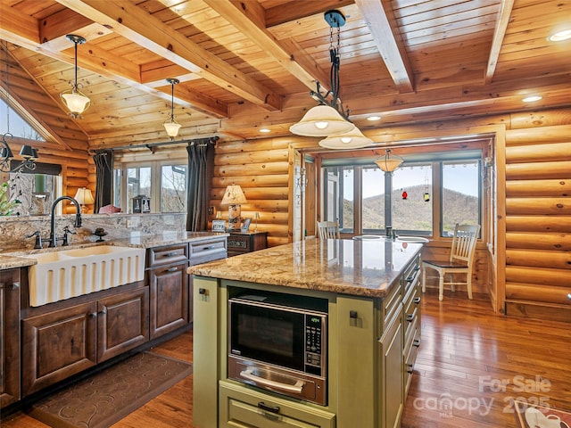 kitchen with wood ceiling, dark wood-type flooring, black microwave, green cabinets, and a sink