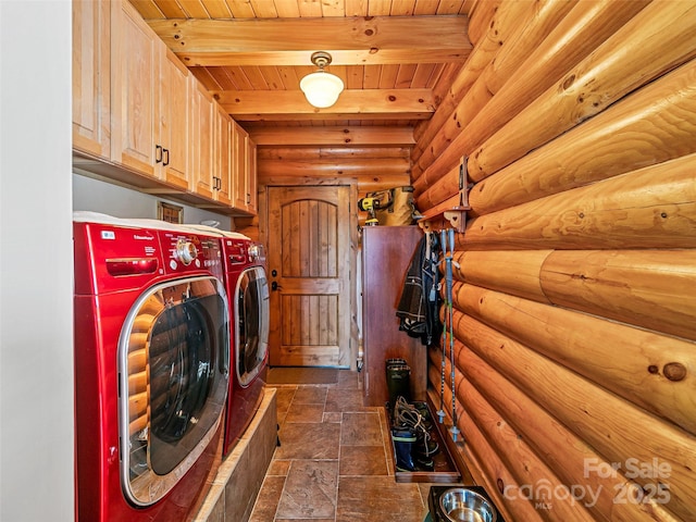 laundry room with stone tile flooring, cabinet space, wooden ceiling, and washer and clothes dryer