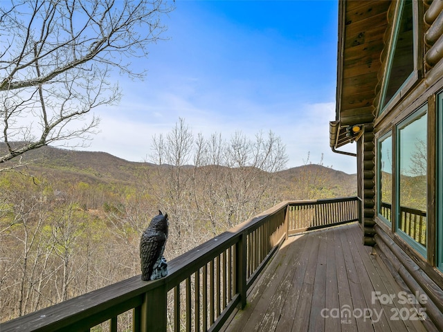 wooden deck with a mountain view