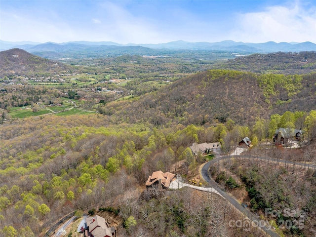 bird's eye view with a mountain view and a wooded view