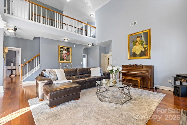 living room featuring hardwood / wood-style flooring and a high ceiling