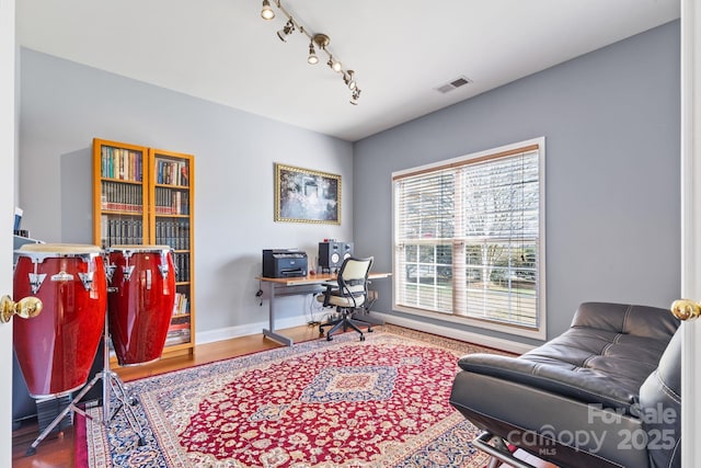 office area featuring hardwood / wood-style floors and track lighting