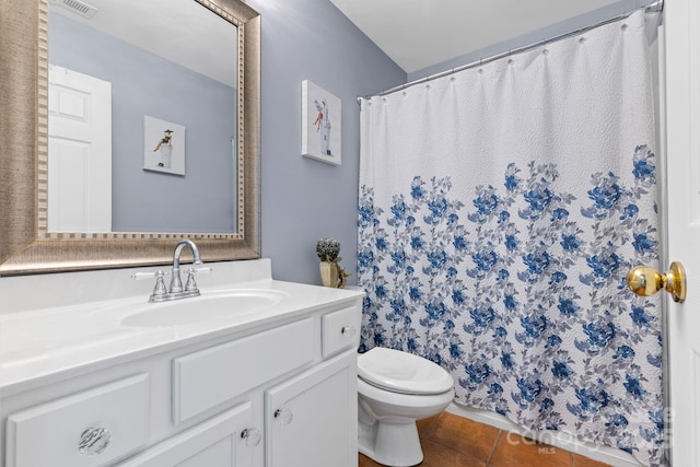 bathroom with vanity, toilet, and tile patterned floors