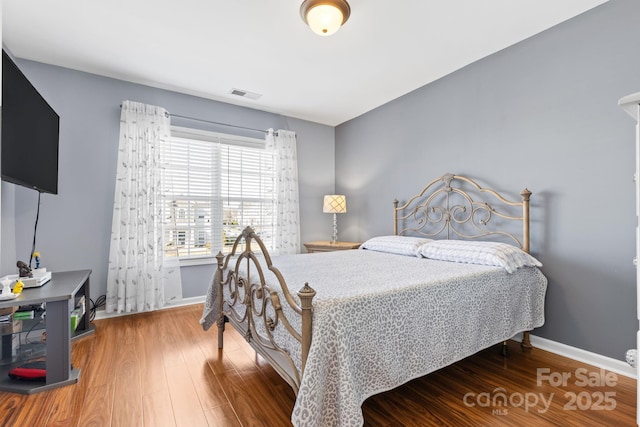 bedroom featuring wood-type flooring