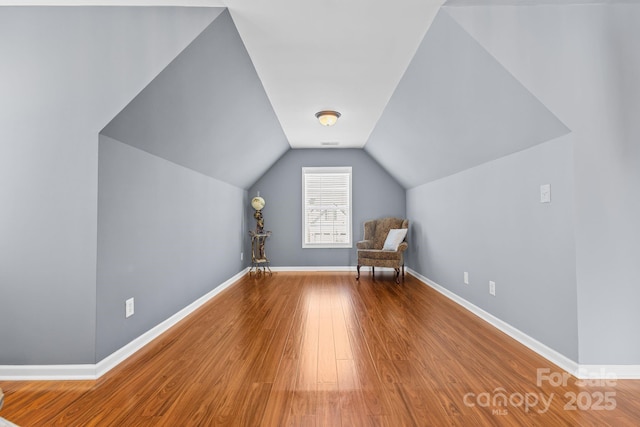 bonus room featuring hardwood / wood-style flooring and vaulted ceiling