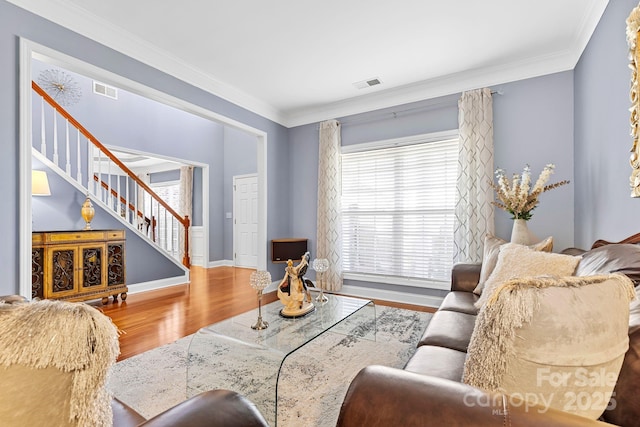 living room featuring hardwood / wood-style flooring and crown molding