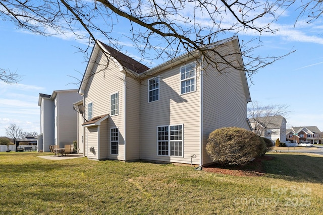 view of home's exterior with a lawn and a patio area