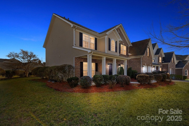 view of front of house with a lawn and a porch