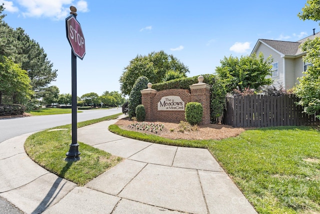 community / neighborhood sign with a lawn