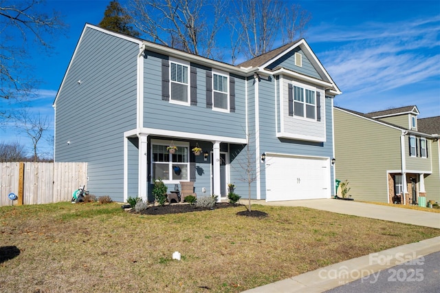 view of front of home with driveway, an attached garage, fence, and a front yard