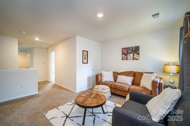 carpeted living area with attic access, visible vents, and baseboards