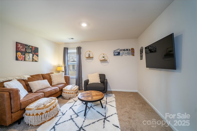 carpeted living room with visible vents and baseboards