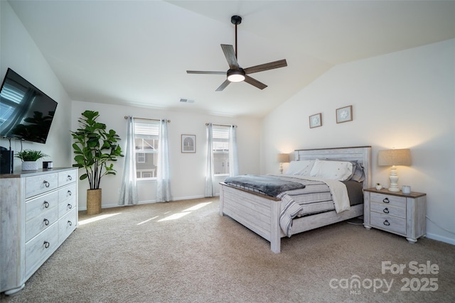 carpeted bedroom featuring vaulted ceiling, baseboards, visible vents, and a ceiling fan