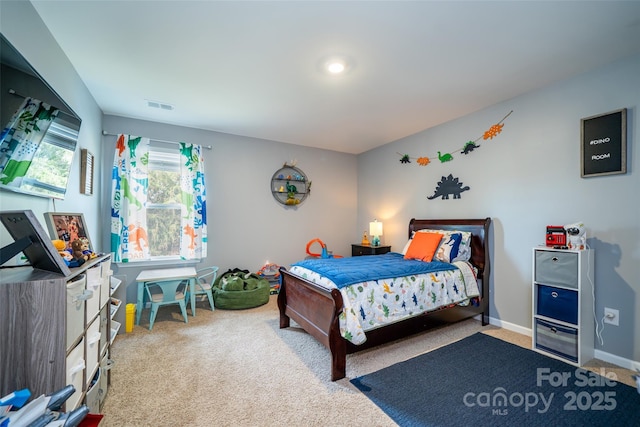 carpeted bedroom featuring visible vents and baseboards