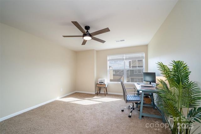 office space with carpet floors, baseboards, visible vents, and ceiling fan